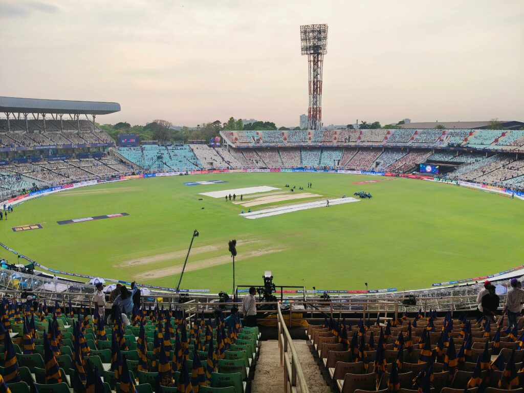 Cricket stadium during an international match showcasing the playing field and stands